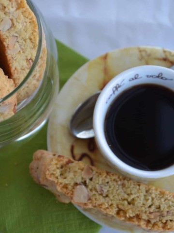An overhead view of an espresso cup and almond biscotti.