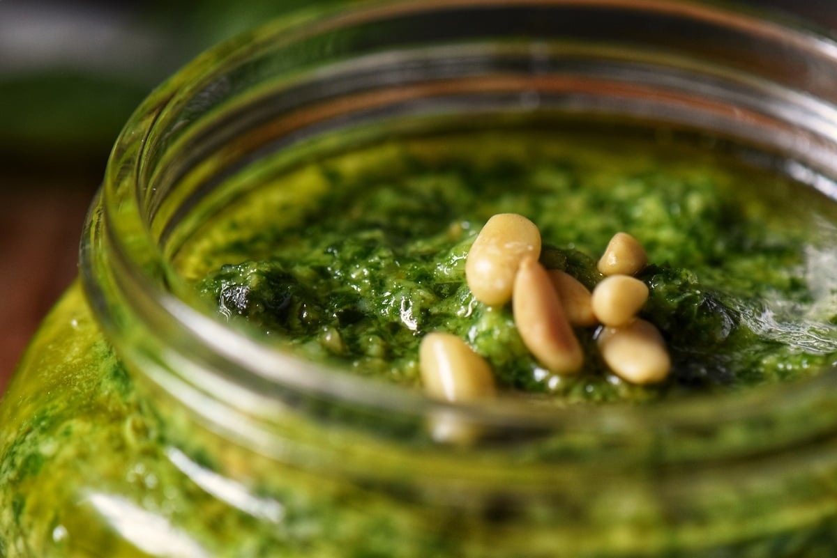 A close up of the top layer of pesto sauce. 