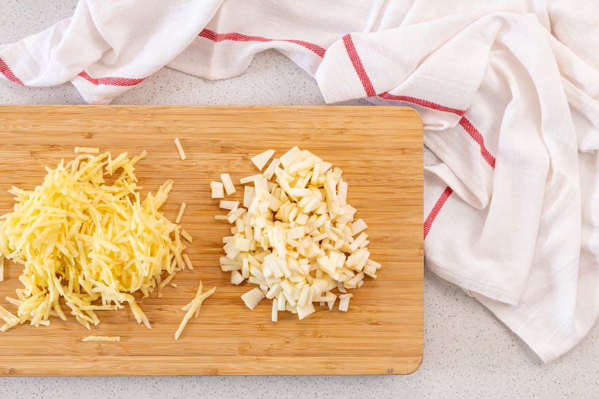 Chopped and grated apples on a wooden board.