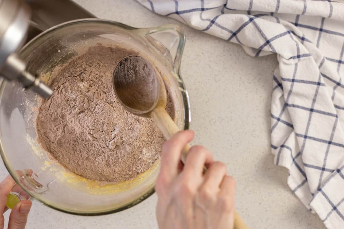 The dry ingredients are being added to the wet ingredients in order to make this easy biscotti recipe.