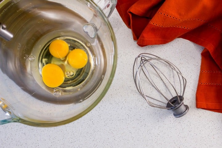 Eggs in the bowl of a stand mixture.