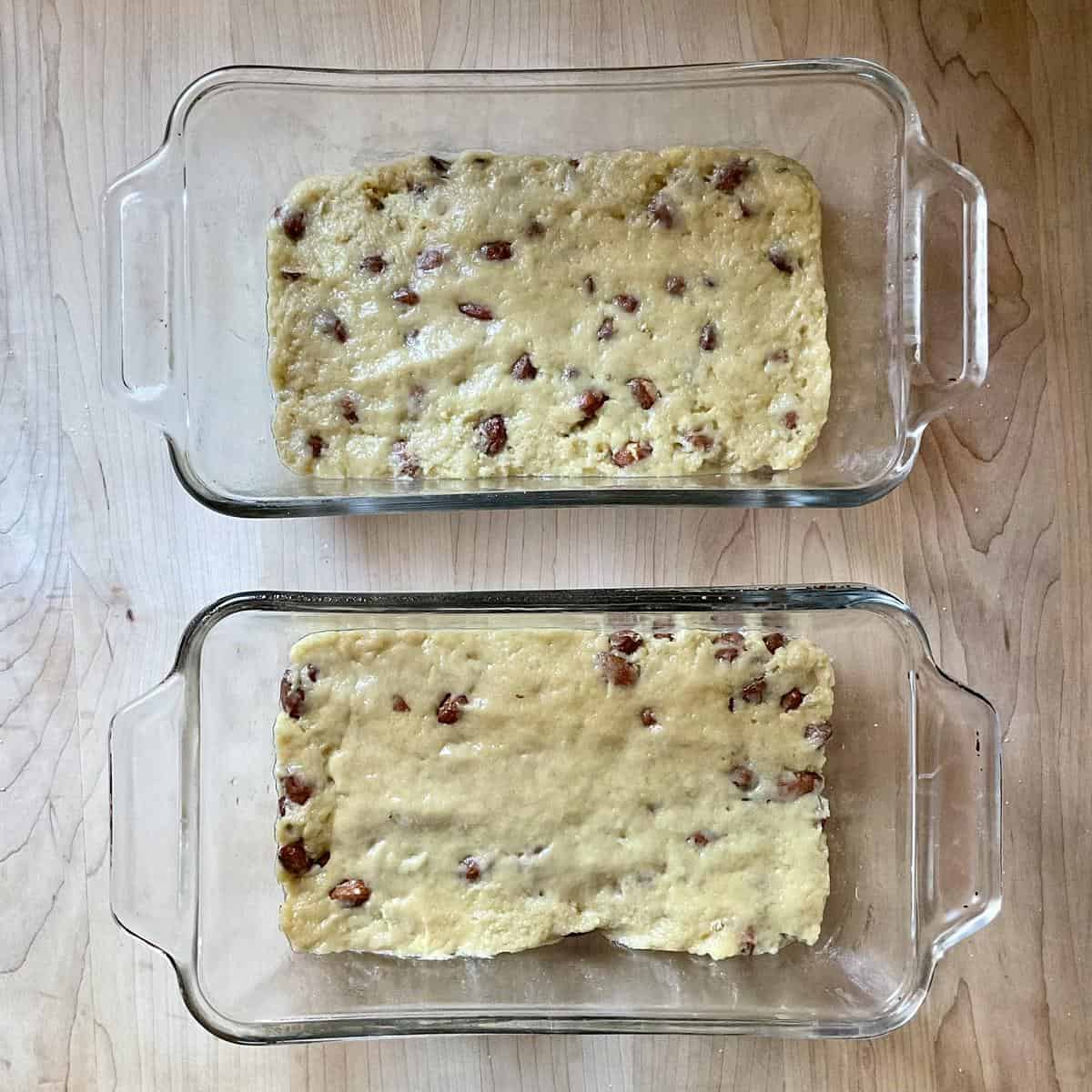 Almond bread dough in two loaf pans.