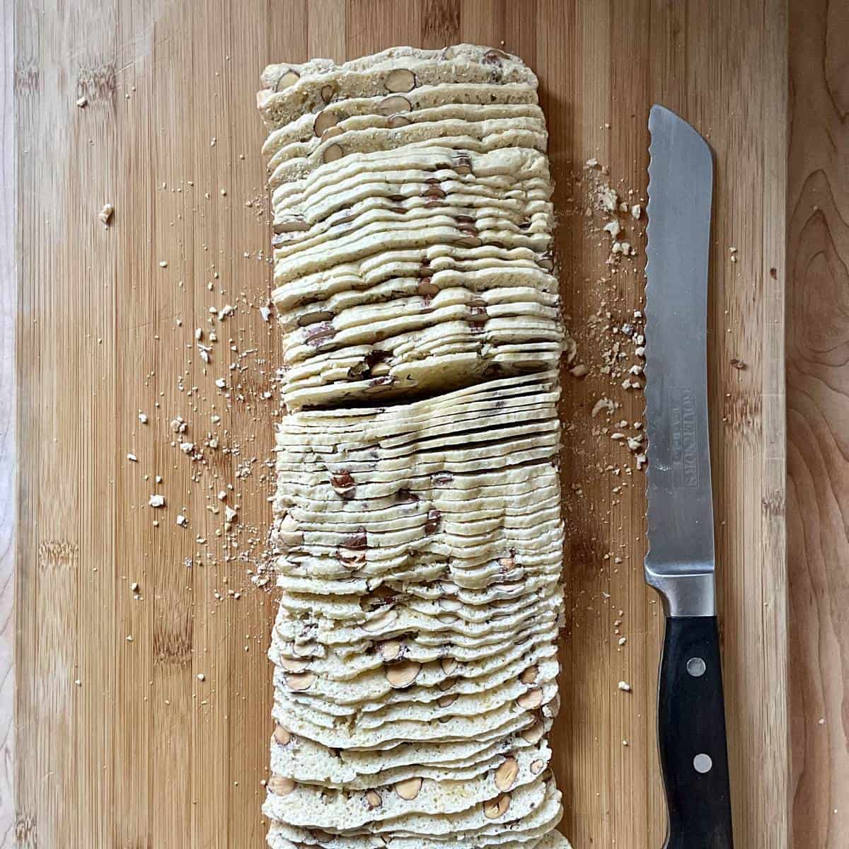 An overhead photo of a thinly sliced almond bread loaf.