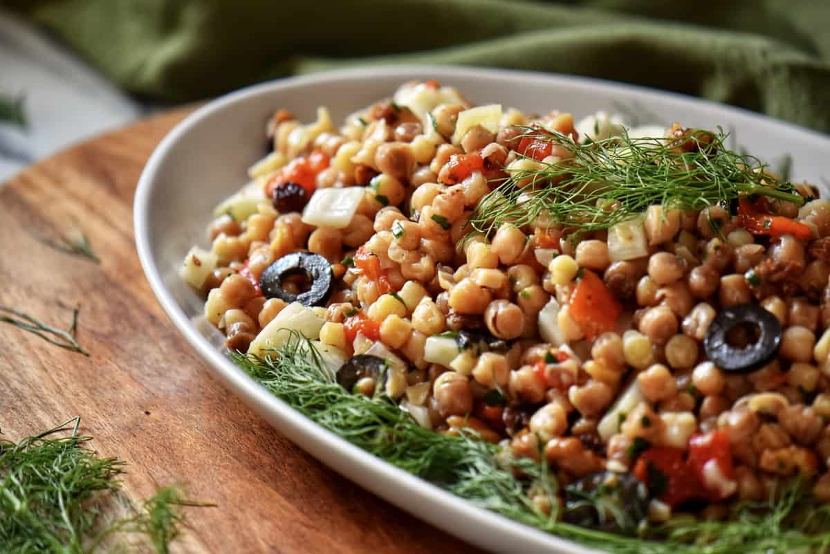 Fregola pasta recipe on a white serving dish.