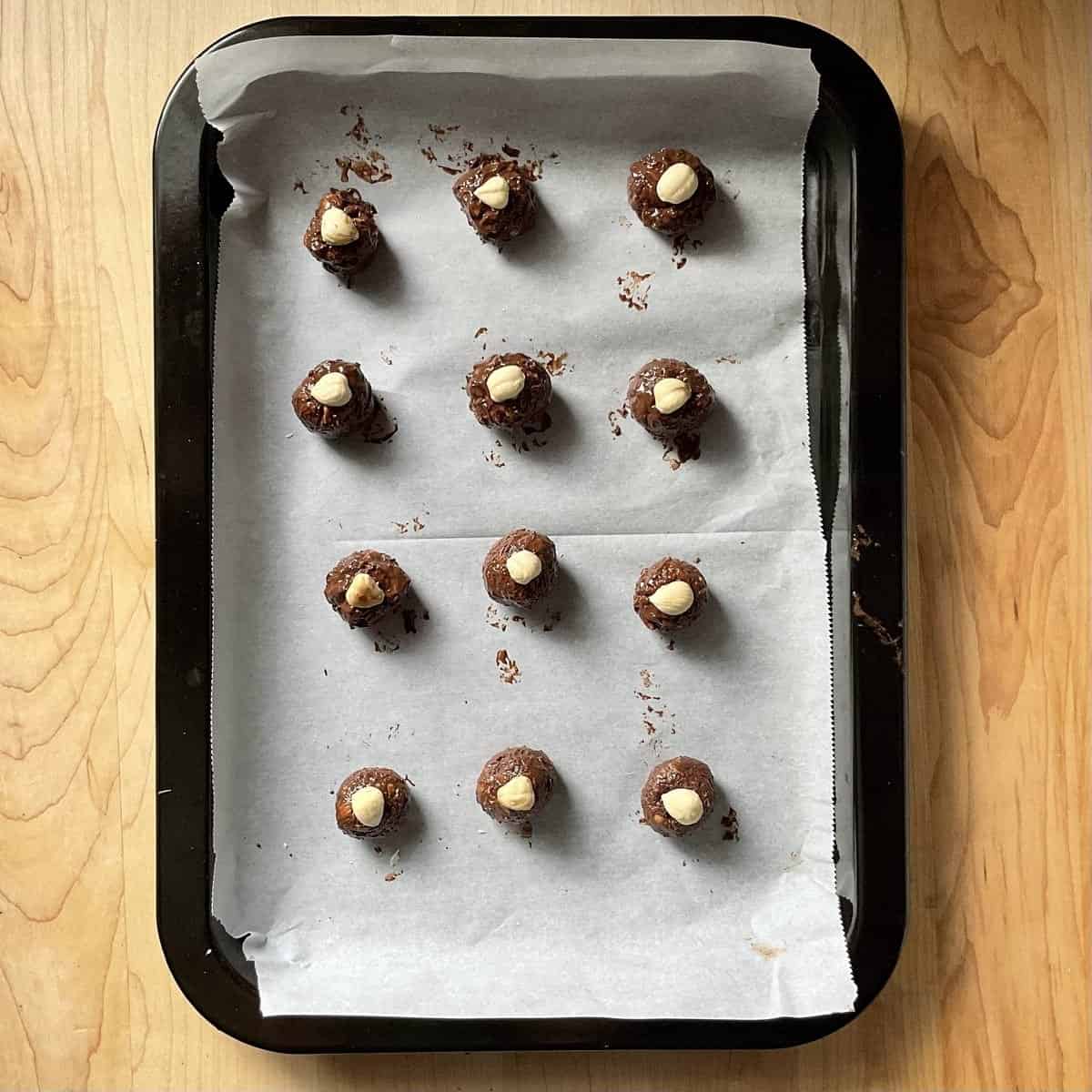 Homemade Baci chocolate on a parchment-lined tray.