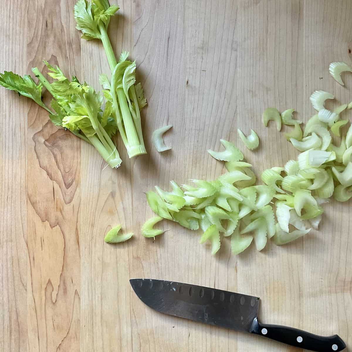 Sliced celery on a wooden board.