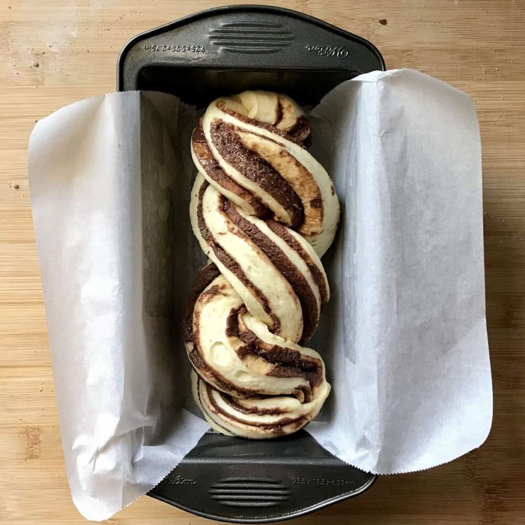 Braided bread in a loaf pan.