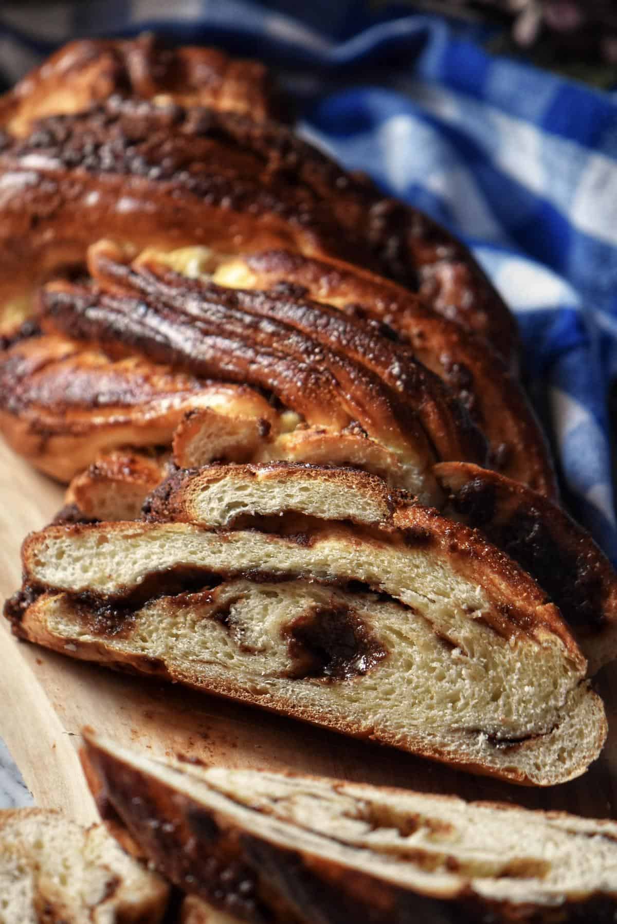 A stunning loaf of braided sweet bread on a wooden board.