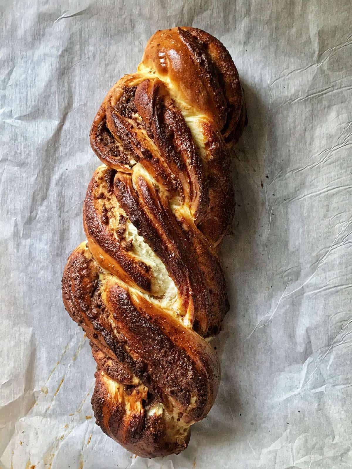 An overhead photo of the golden brown crust of a freshly baked sweet bread.