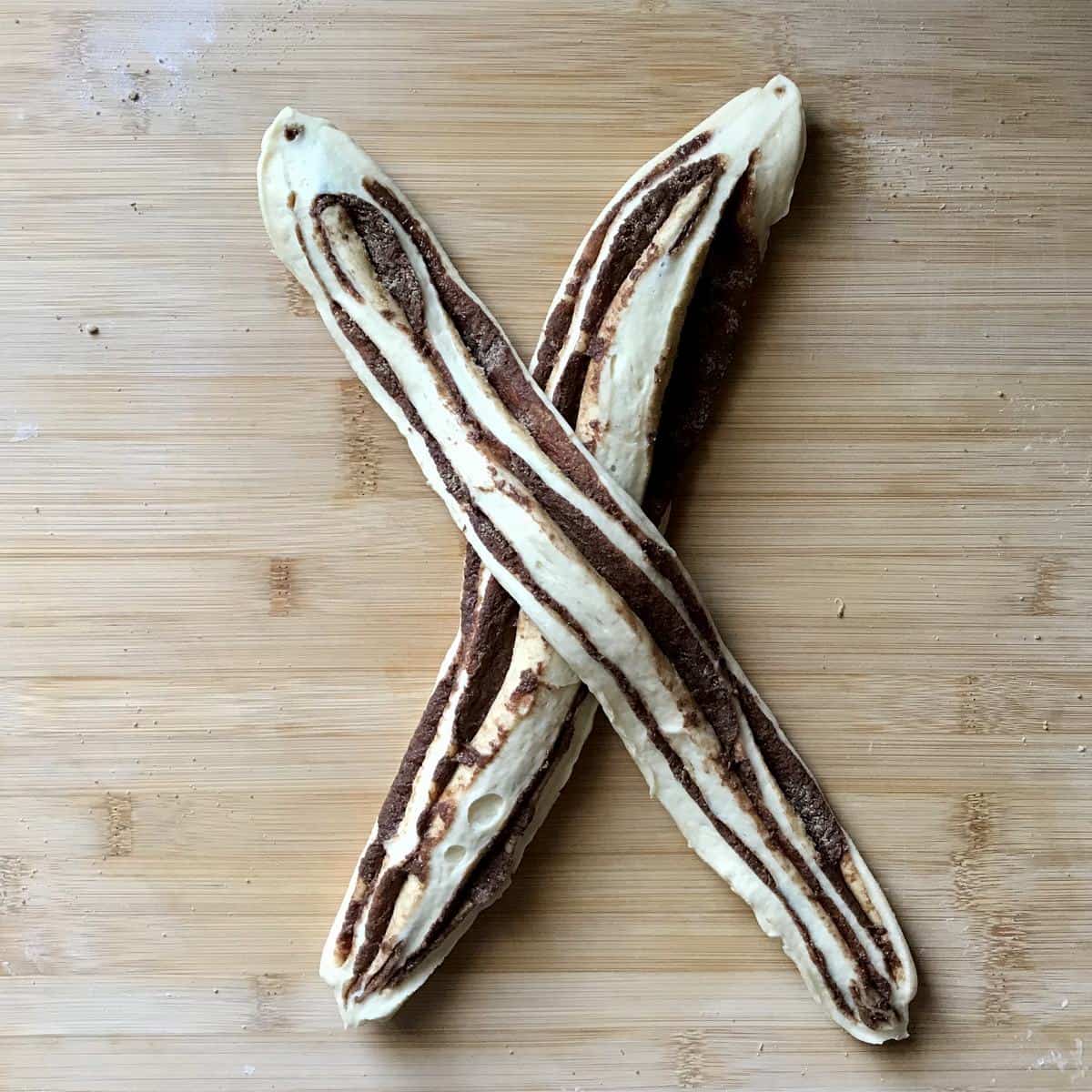 An "X" is formed with the two halves of sweet dough. 