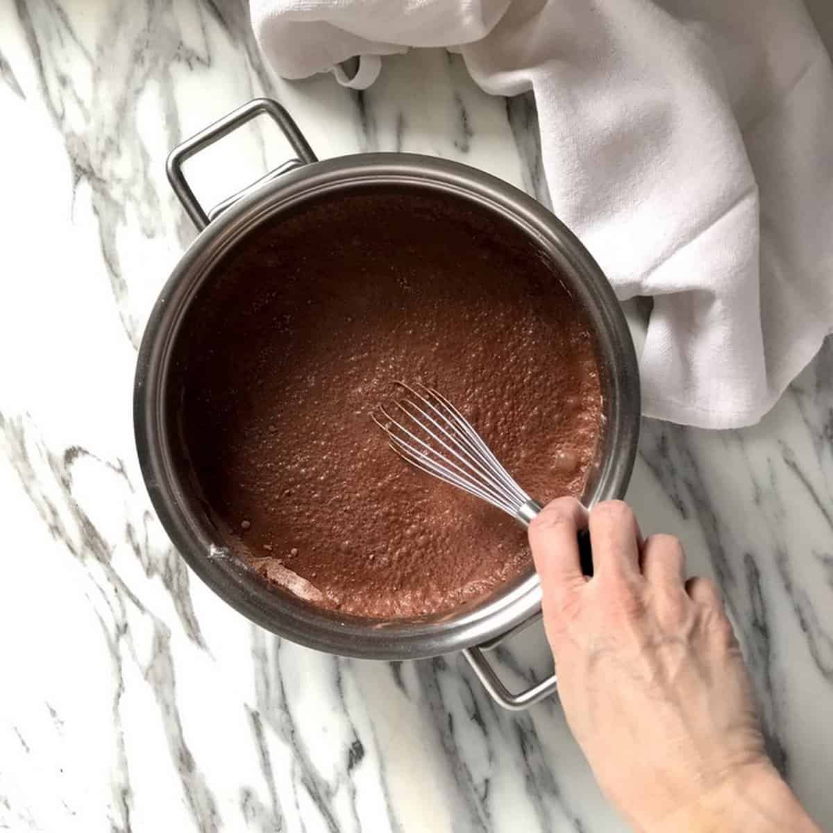 Homemade pudding from scratch begins by combining the dry and the wet ingredients.