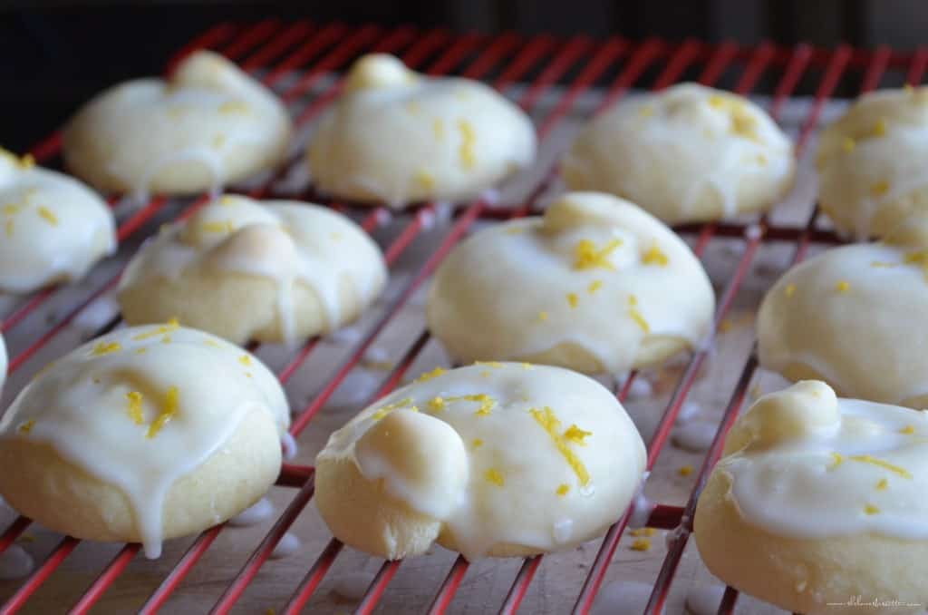 Iced Italian lemon Cookies are on a cooling rack.