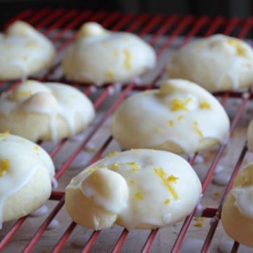 Iced Italian lemon Cookies are on a cooling rack.