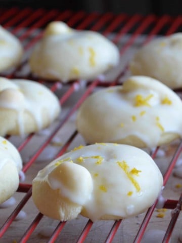 Iced Italian lemon Cookies are on a cooling rack.