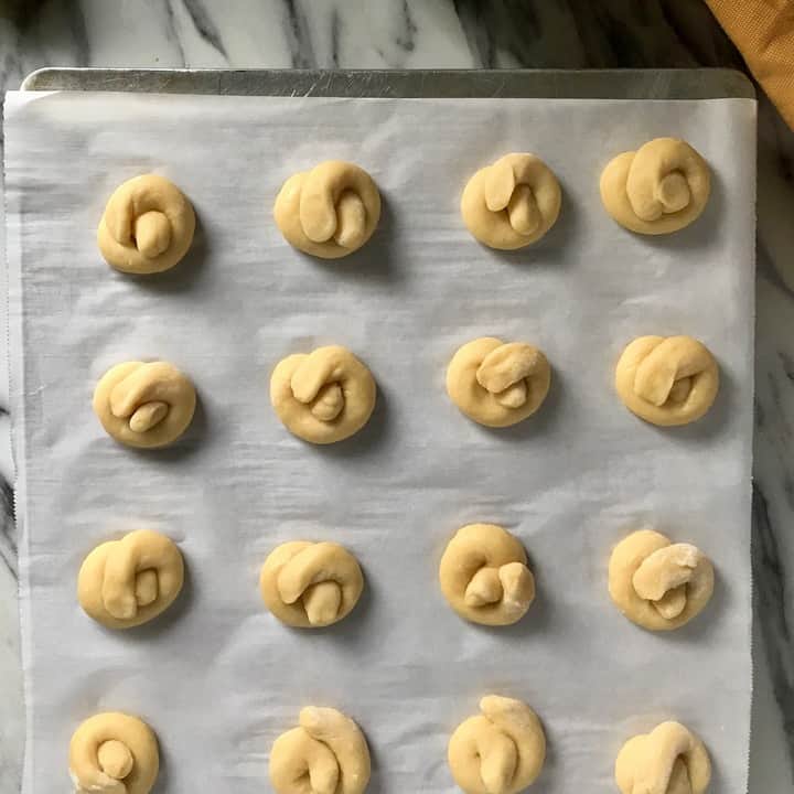 Lemon knot cookies on a baking tray.