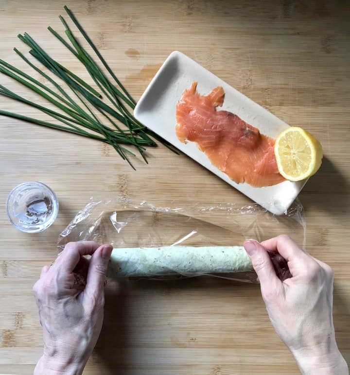 The smoked salmon and cream cheese roll ups are wrapped in a piece of cellophane.