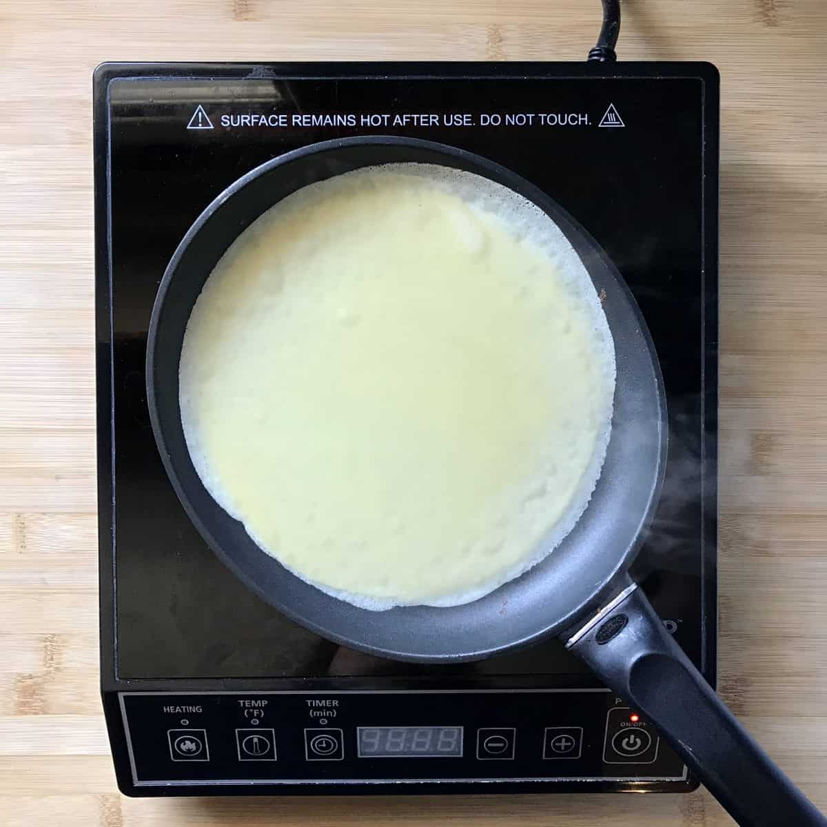 Crepe batter in a crepe pan.