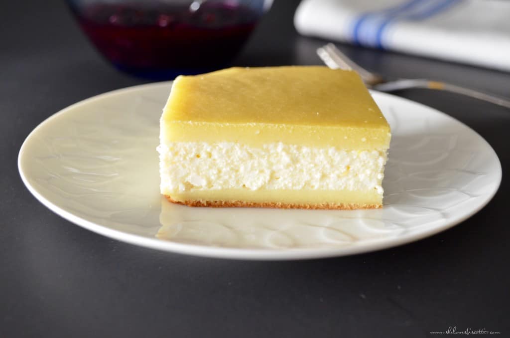 A plain square piece of cheese blintze on a white plate.