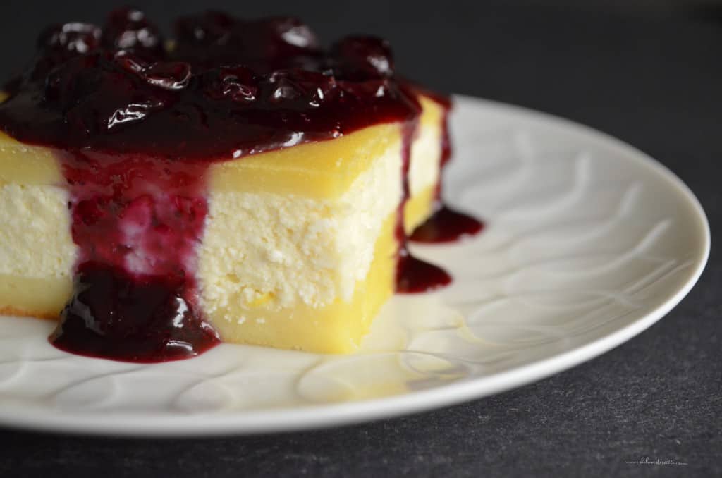 Blueberry sauce dripping off the side of a piece of cheese blintz.