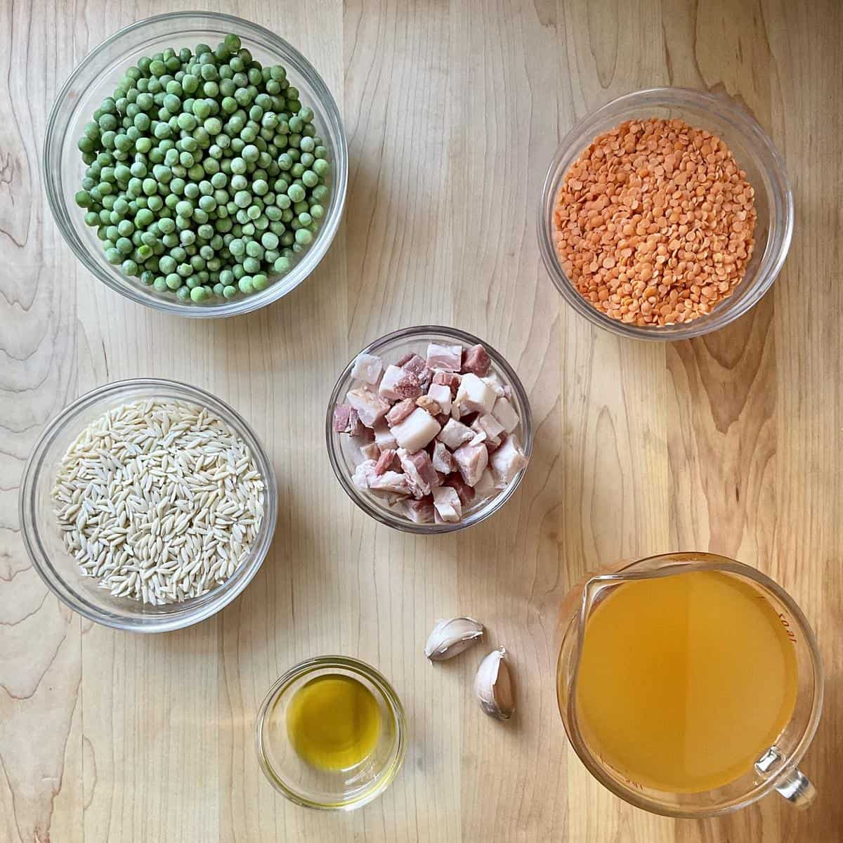 The individual ingredients to make orzo risotto in bowls.