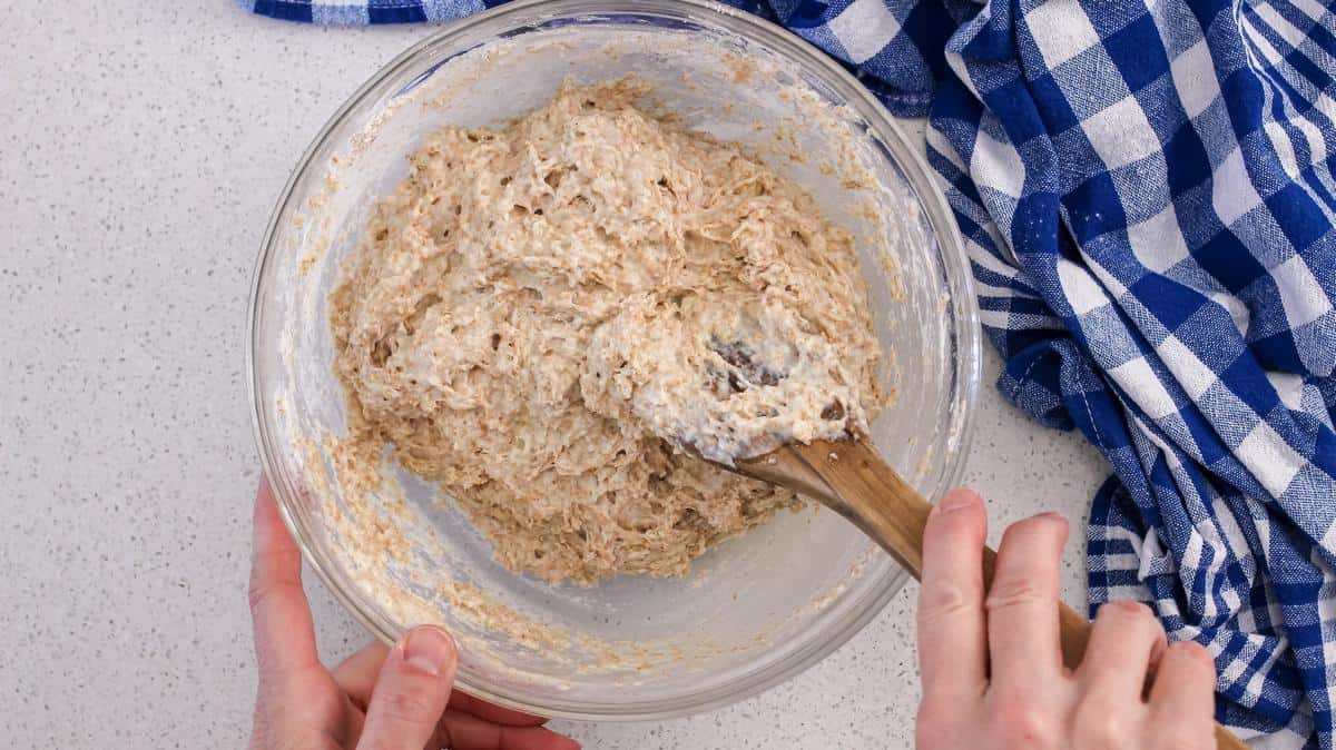 An overhead shot the honey wheat dough in the process of being combined.