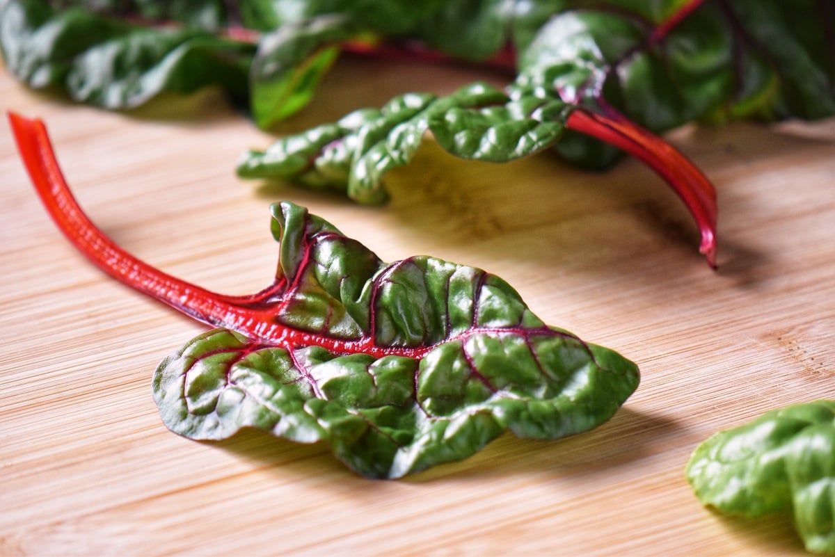 Rainbow chard on a wooden board.