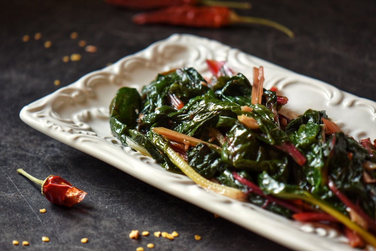 Sauteed chard in a white serving dish.