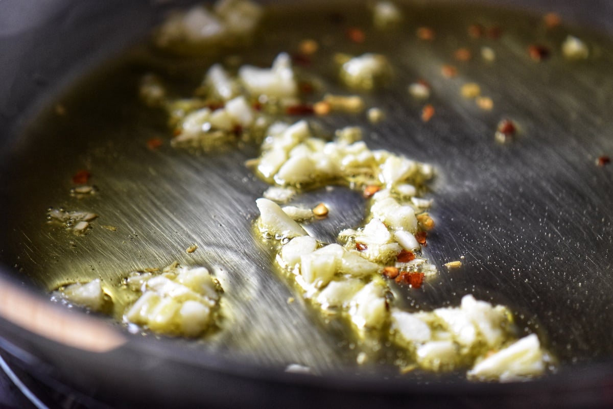 Sauteed chopped garlic in a pan.