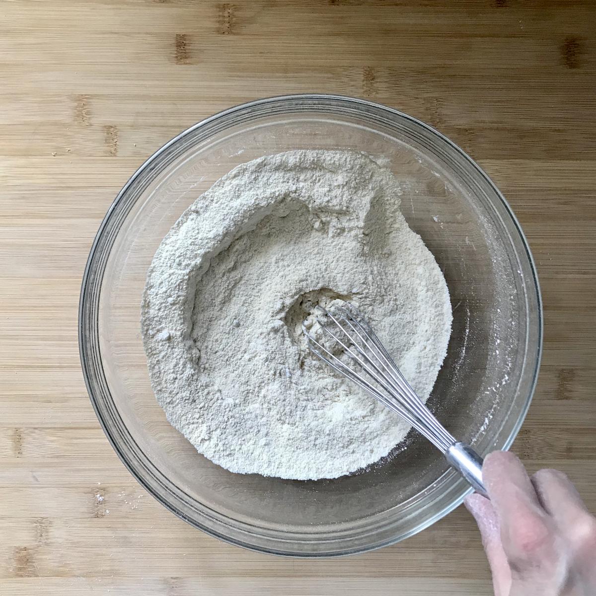 The dry ingredients for the lemon scones being whisked together.