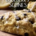 Blueberry Scones with blueberries on a wooden board.