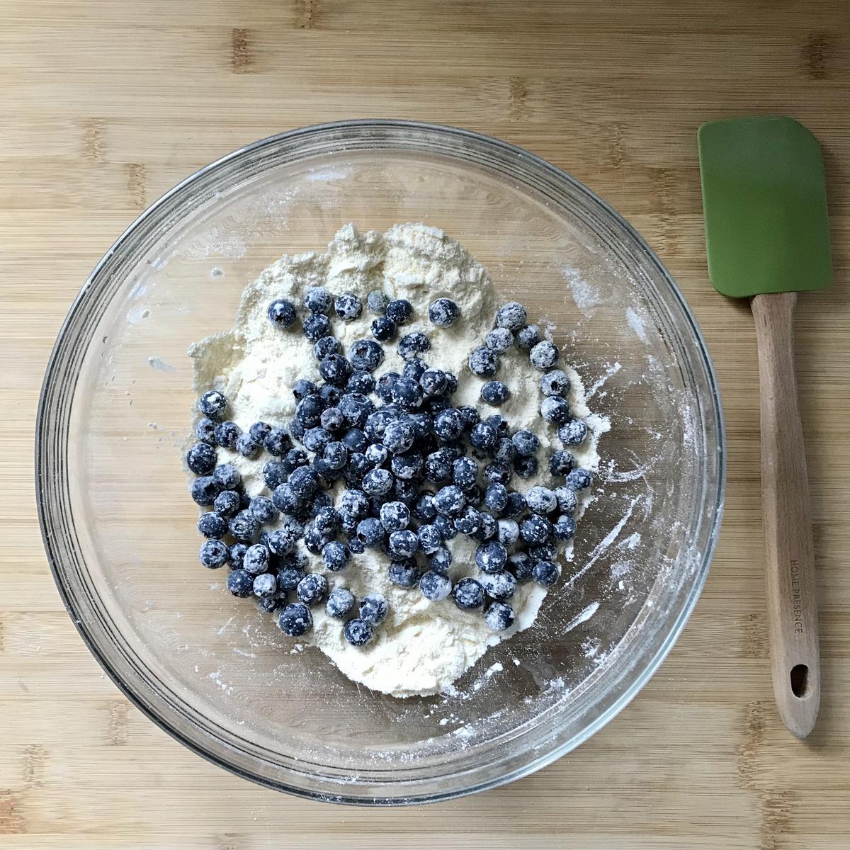 Blueberries being folded in the dry mixture.