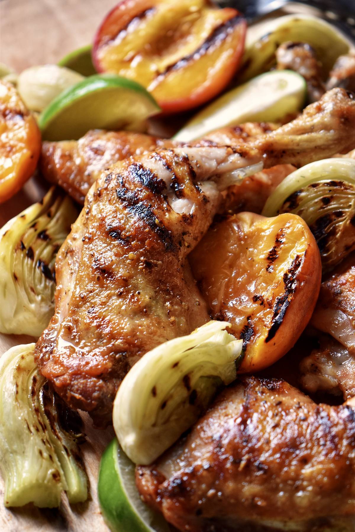 An close up photo of a grilled chicken leg quarter.