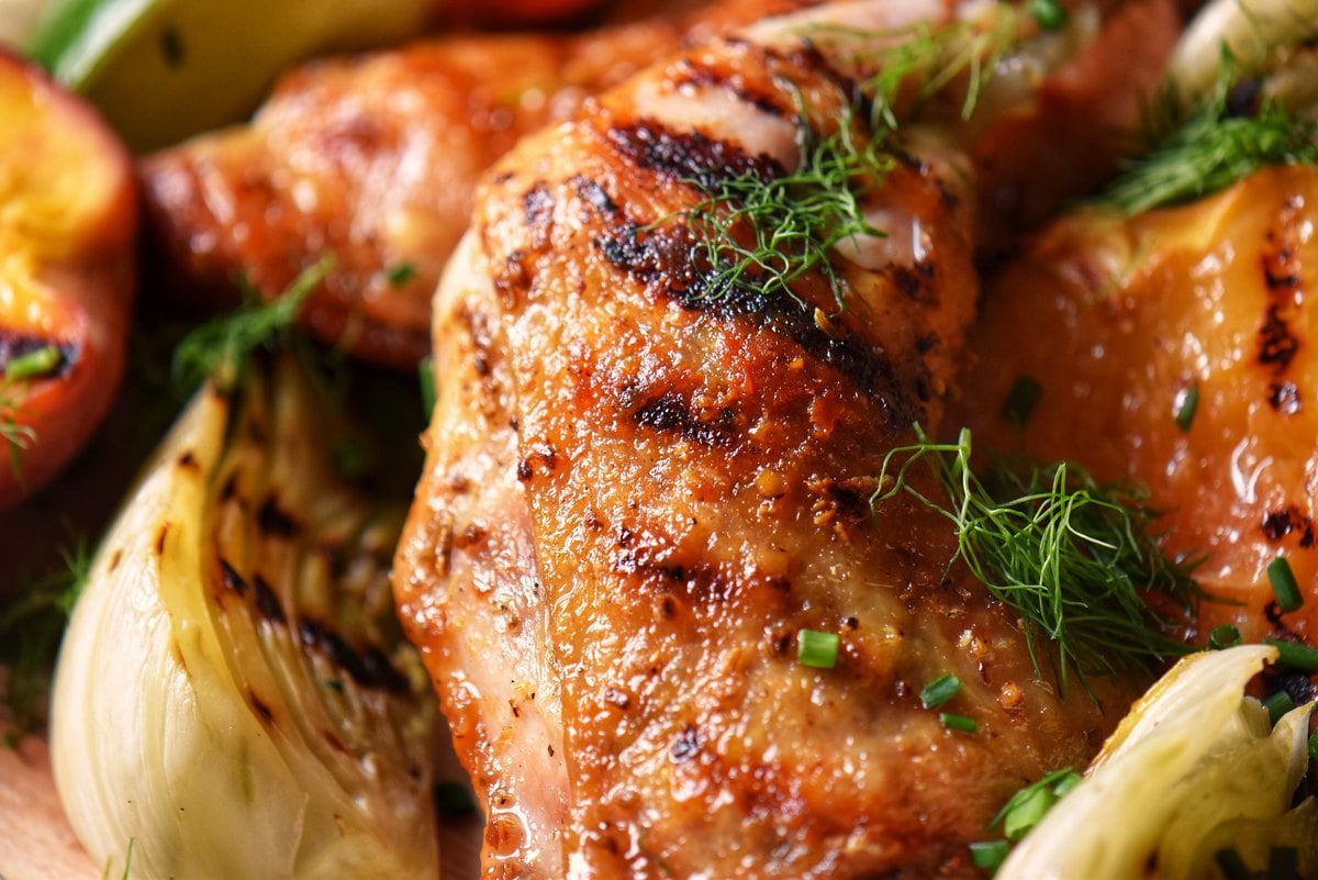 A close-up photo of grilled chicken with fennel.