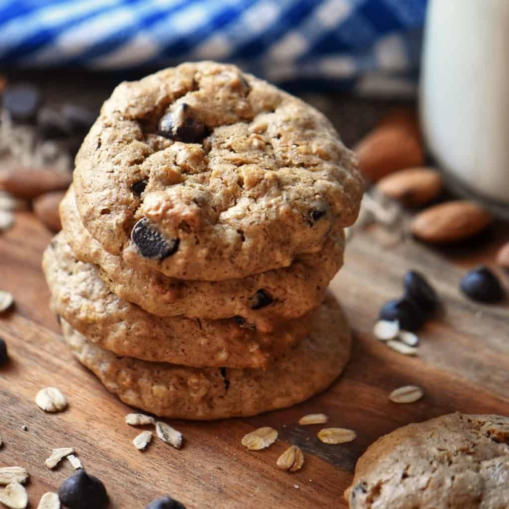 A stack of Oatmeal Almond Butter Cookies on a wooden board.