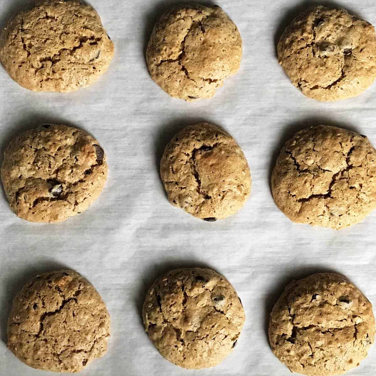 Freshly baked cookies on a parchment lined baking sheet.