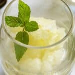 Italian Lemon Ice in a glass decorated with a sprig of mint.