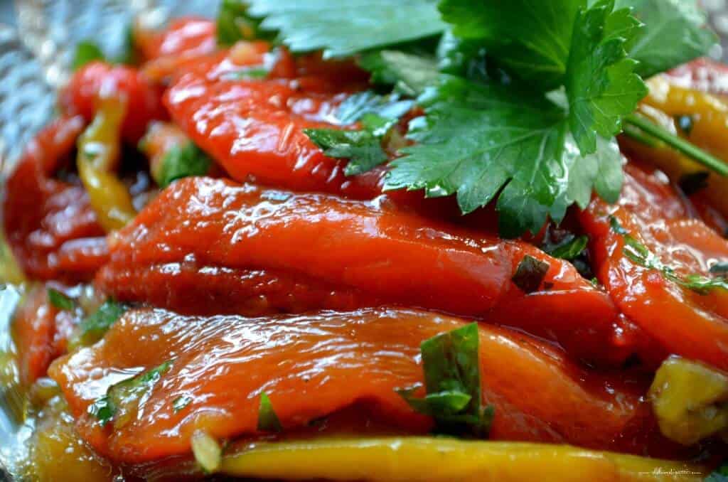 A close up shot of red peppers in the marinade.