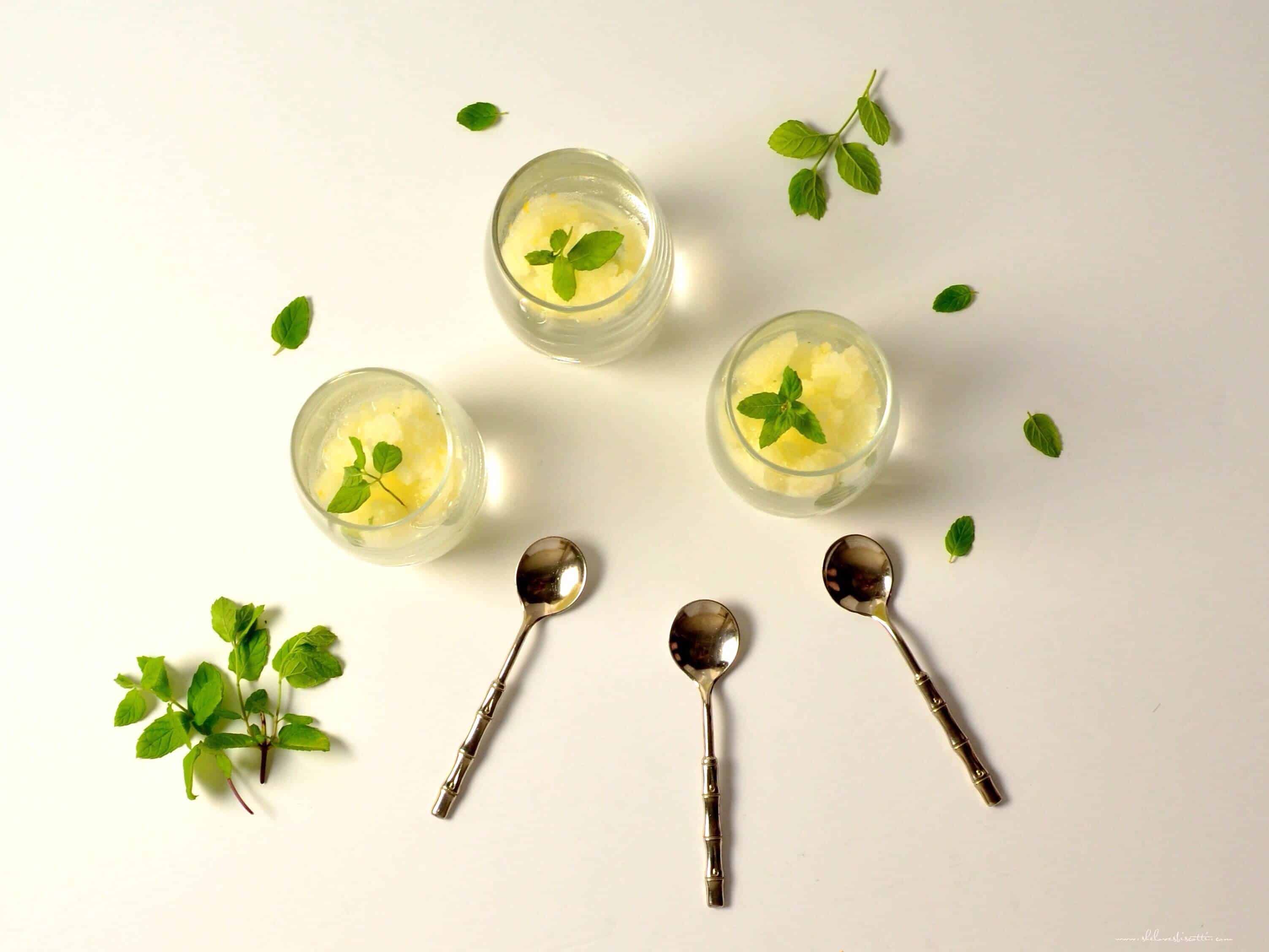 Mint placed decoratively on the serving dishes of Lemon Ice.