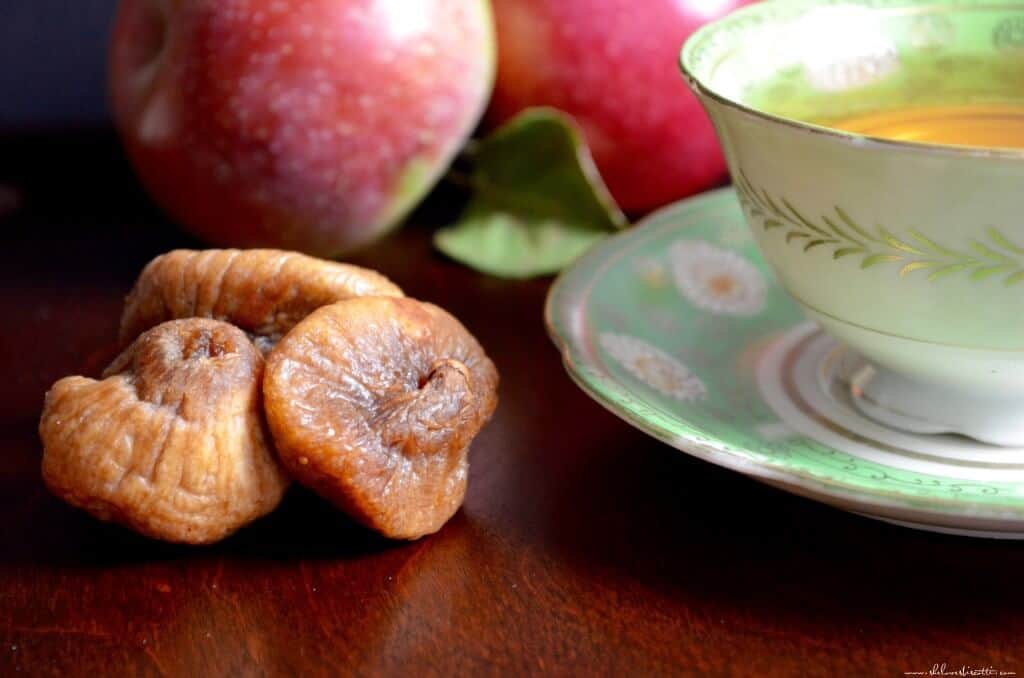 Dried figs on a wooden surface. 