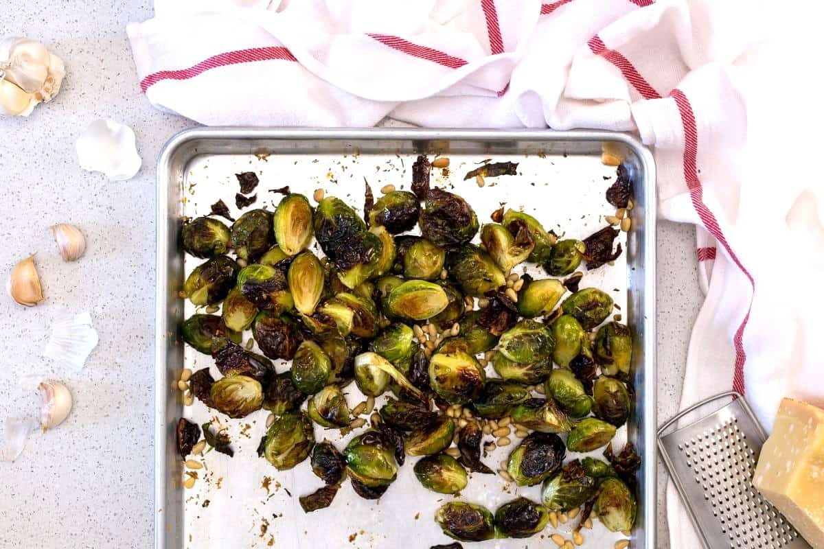 Roasted Brussels sprouts with garlic on a sheet pan.