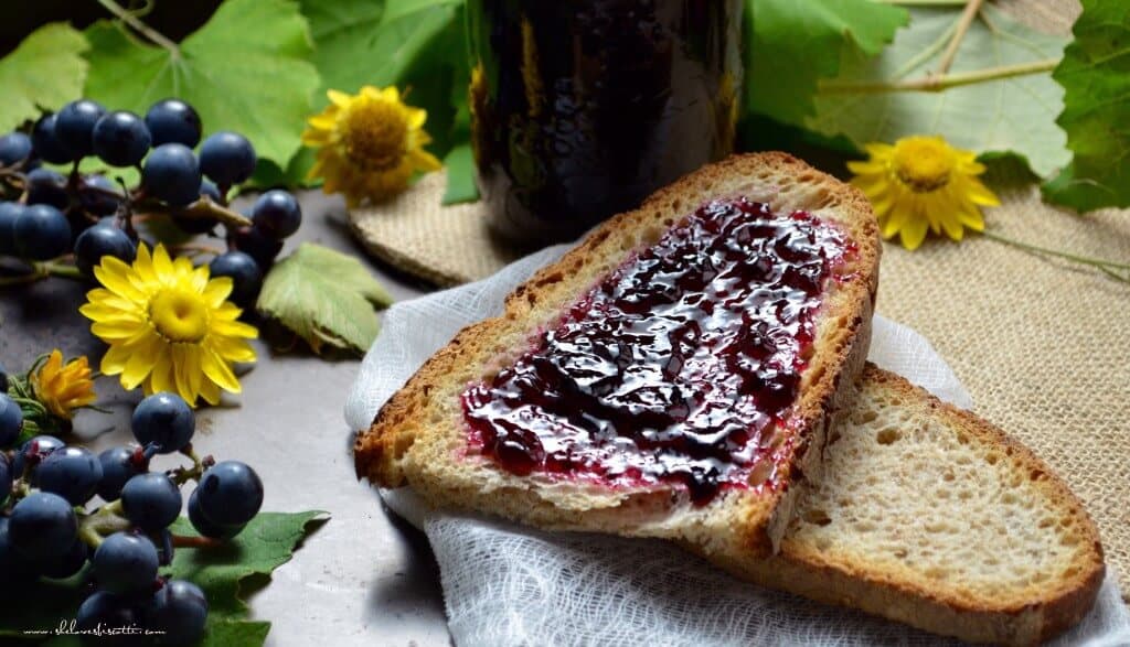 Grape jelly spread across a slice of brown bread.