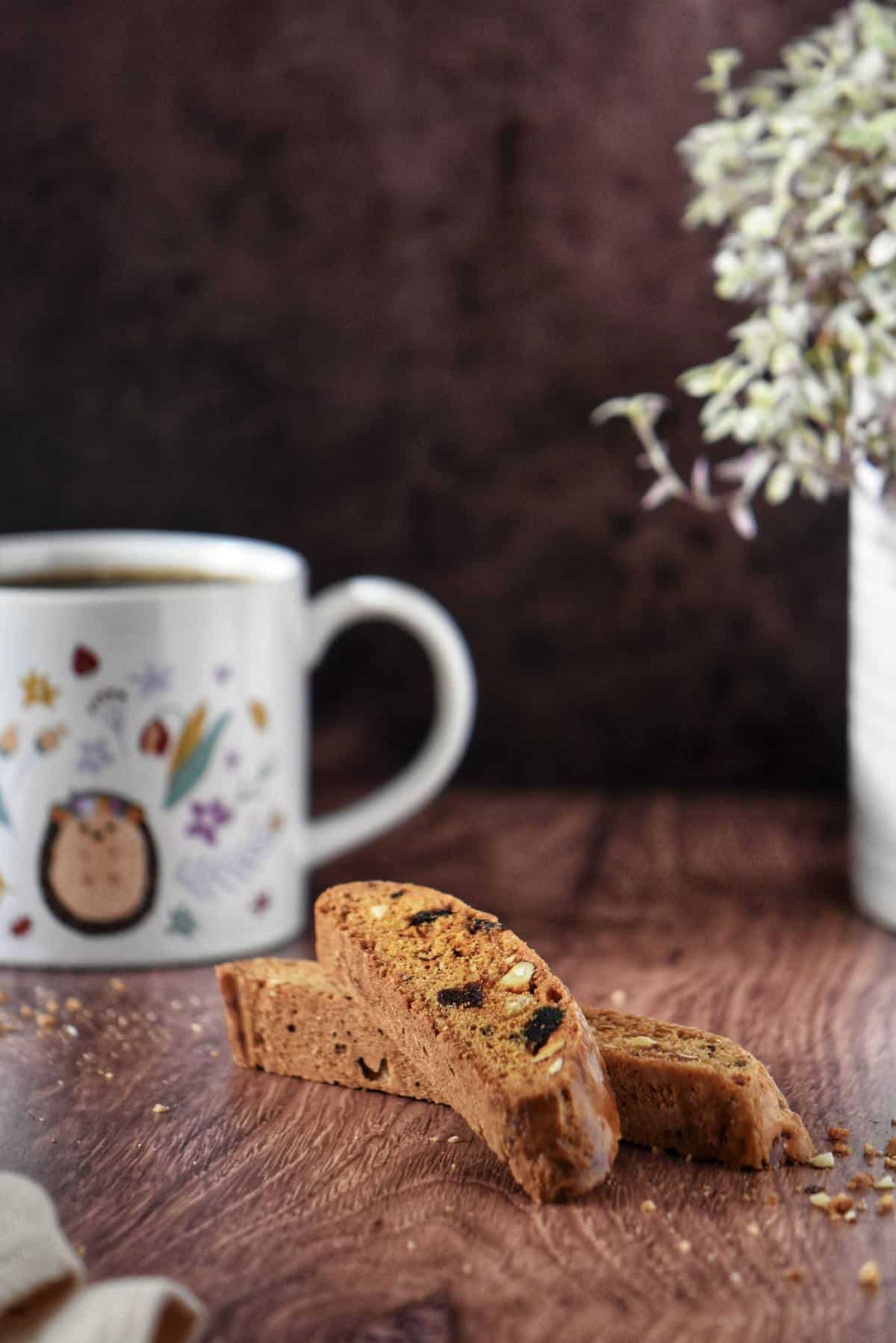 Date Biscotti next to an espresso cup.