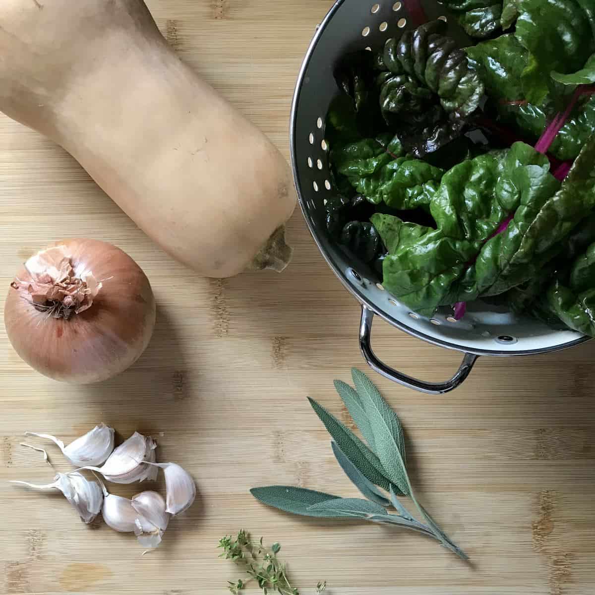 Vegetables and herbs on a wooden board. 