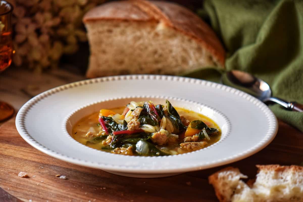 A bowl of sausage and butternut squash soup.