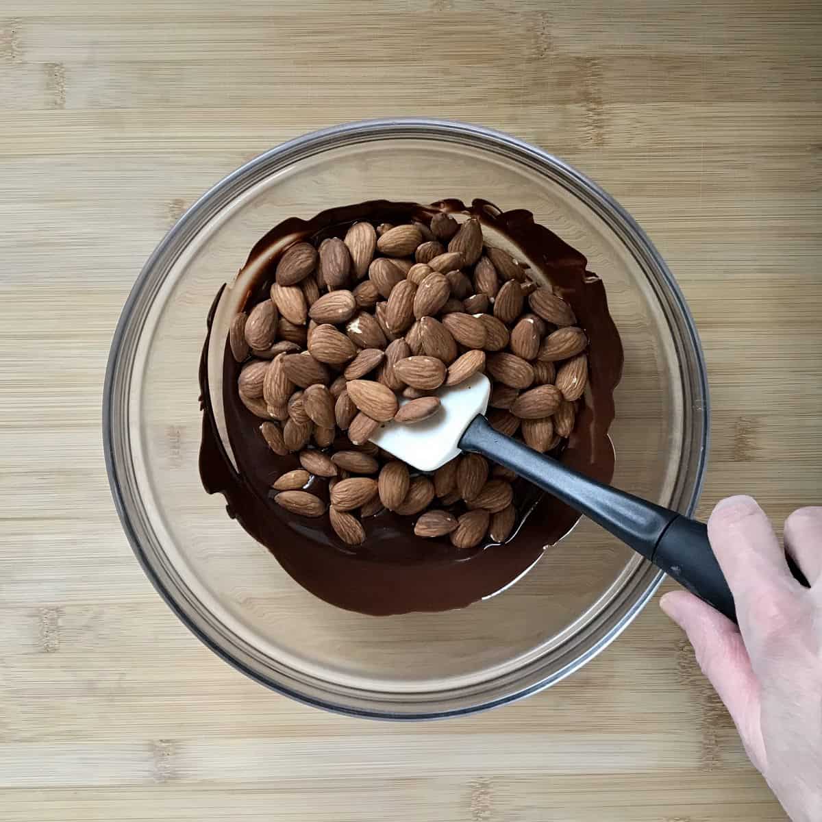 The mixture of chocolate and almonds in a bowl.