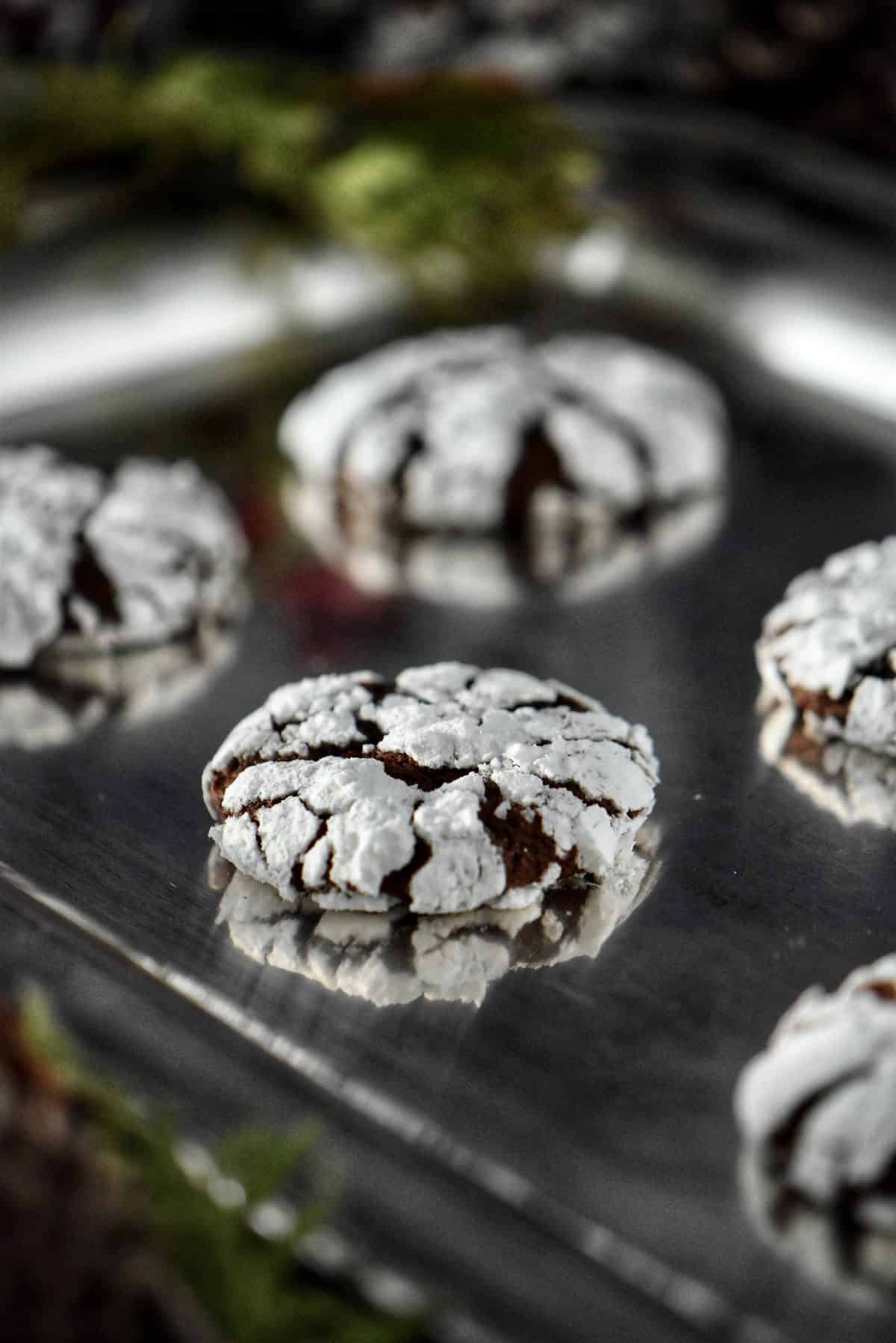 Chocolate snowcap cookies on a silver tray.