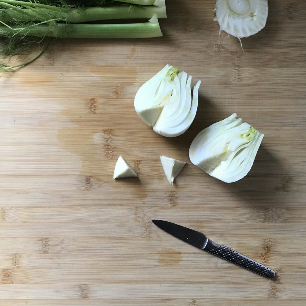 The core is removed from the fennel halves.