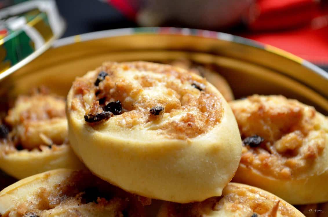 Pinwheel cookie with currants in a festive cookie tin.