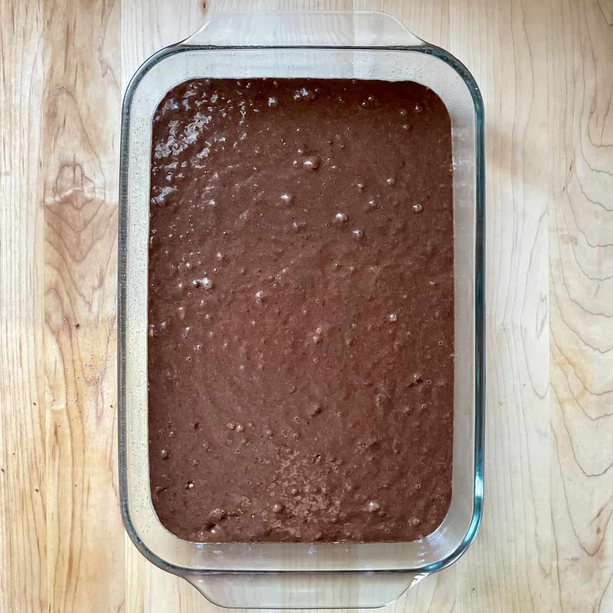 Cake batter in a rectangular baking pan.