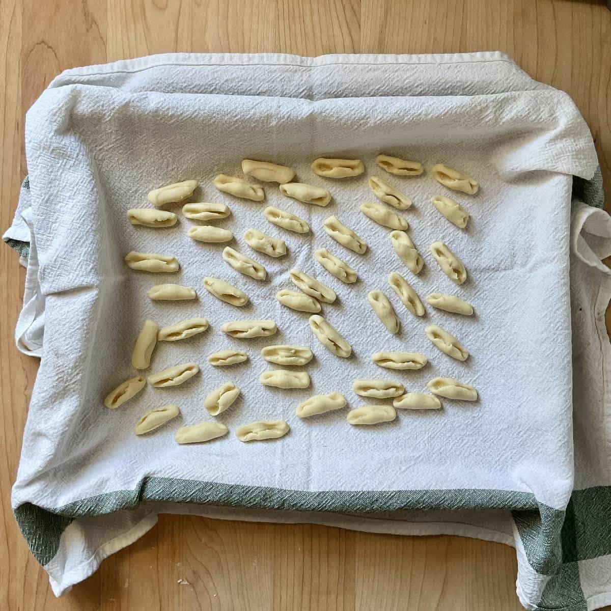 Freshly made pasta on a tea towel. 